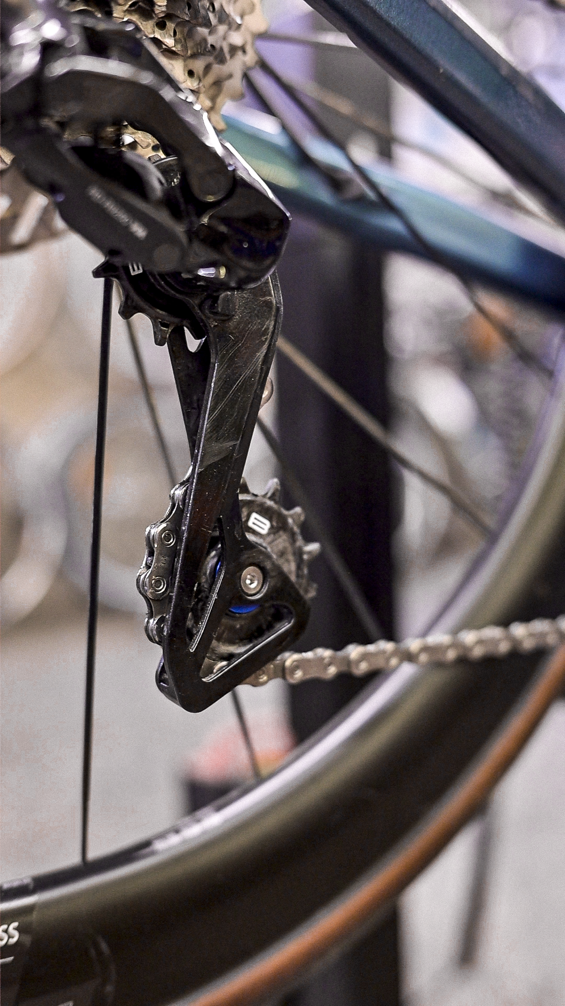 Bikone Forged Carbon Pulley Wheels, installed in a rear derailleur with the chain running through, road bike drivetrain components