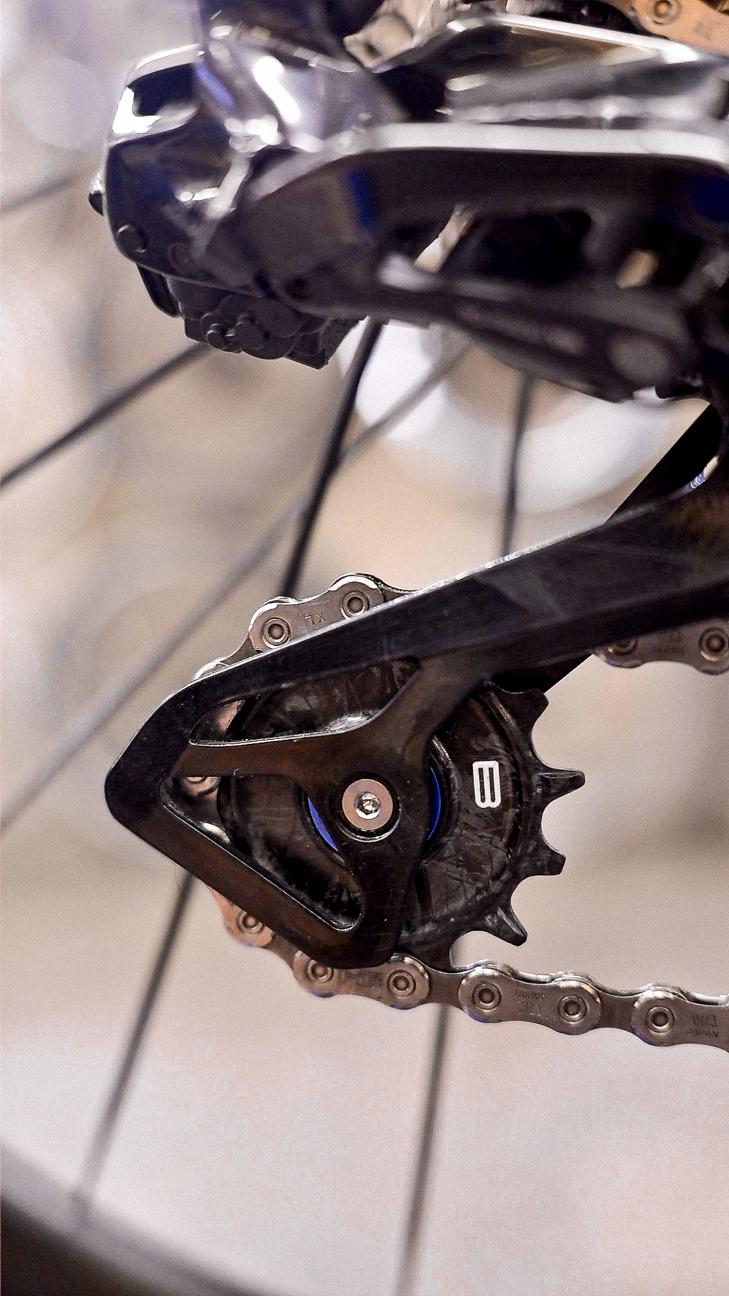 Bikone Forged Carbon Pulley Wheels, lower pulley fitted in a rear derailleur cage, close up, road bike drivetrain components